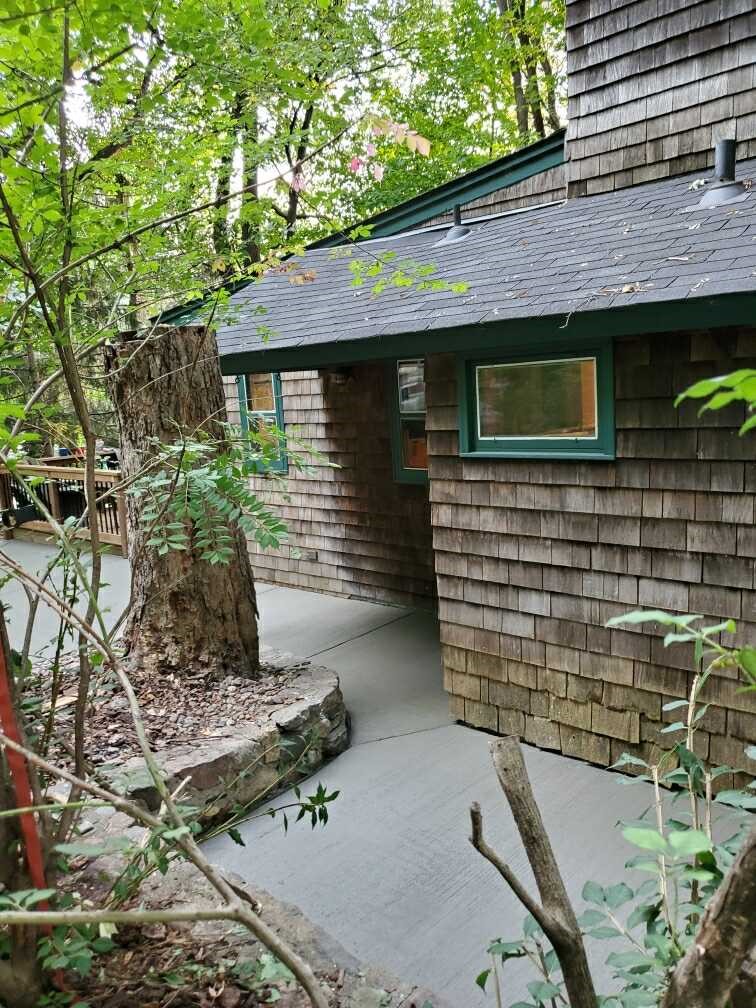 New broom-finish concrete driveway in Brainerd MN with evergreen trees in background